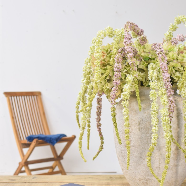 an artificial floral arrangment in pot