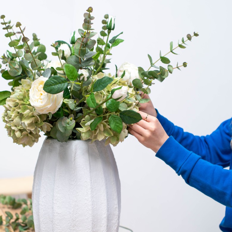 artificial white and green hydrangea in white vase